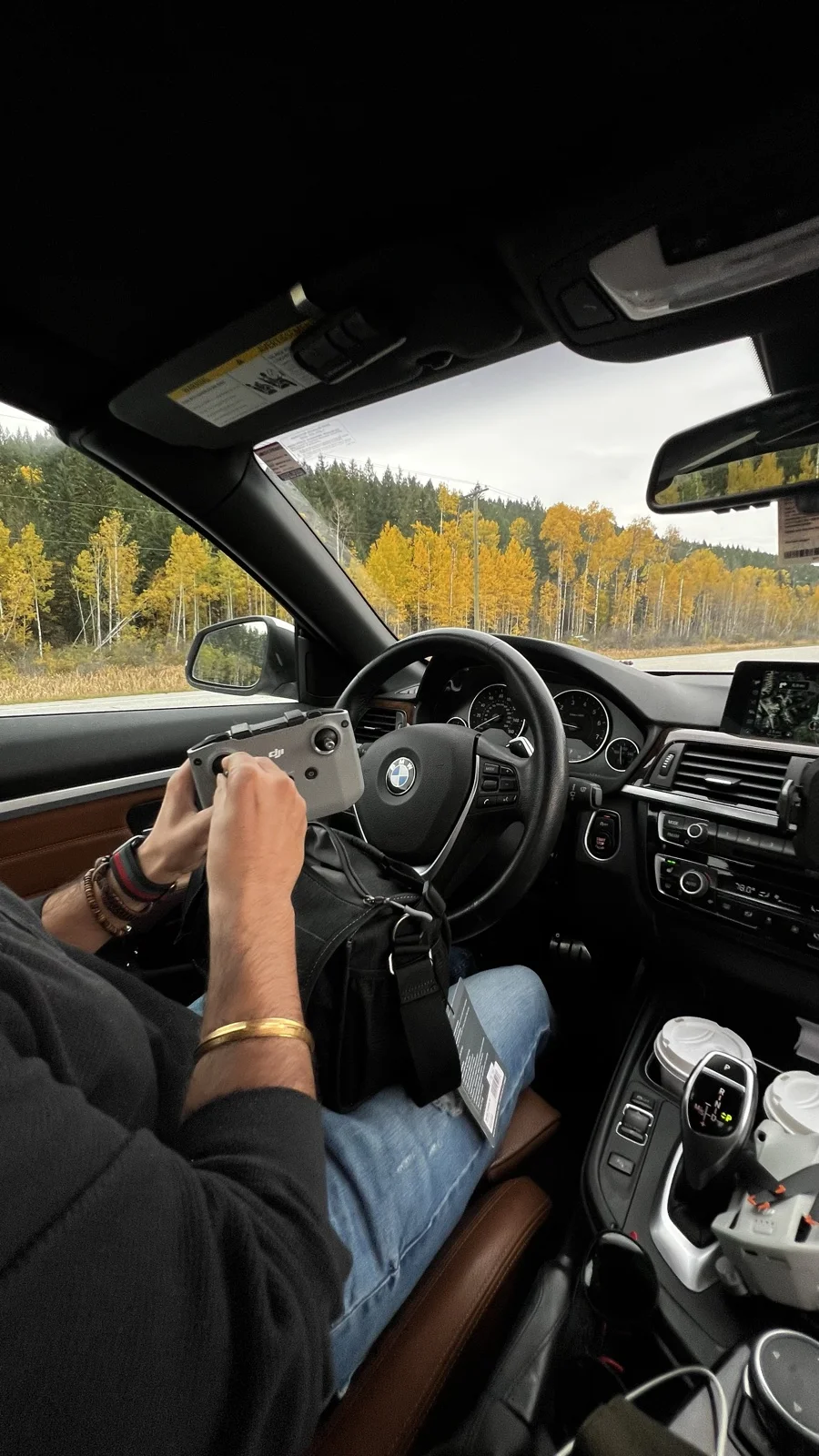Rachit getting ready to fly a DJI drone on an autumn road trip through golden aspen country